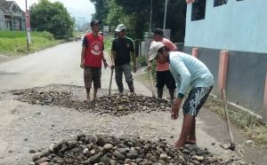 Cegah Laka Susulan, Warga Desa Damarwulan Kediri Gotong Royong Uruk Jalan Berlubang